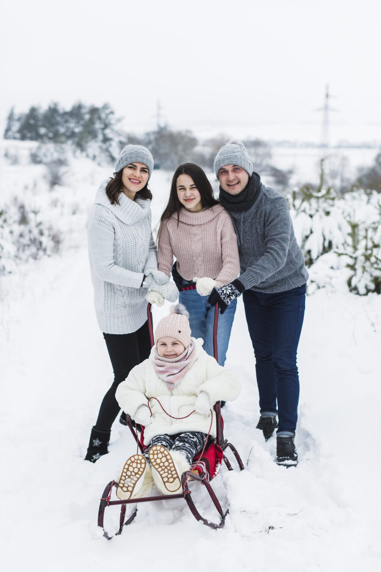 family-posing-with-sleigh residential snow removal 03